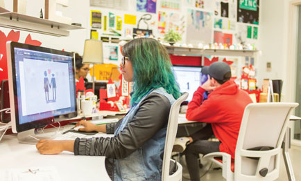 Two students studying on individual desktop computers