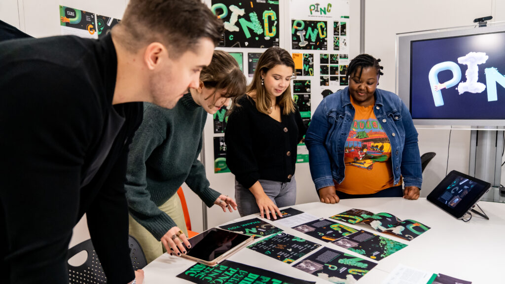 Four students from the Graphic Design and Motion Design majors collaborate on event branding project for a client.