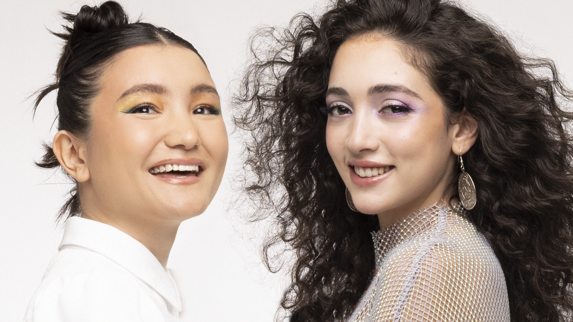 A composite of headshots of two girls looking at the camera and smiling.