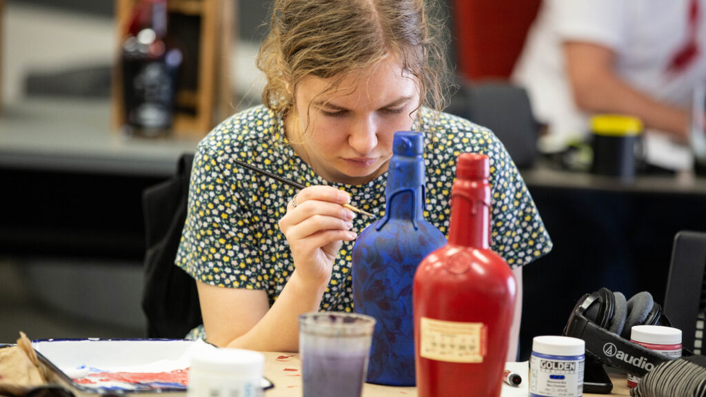 Students working on their bottles at the INDEX hosted workshop for the Make Your Mark project.